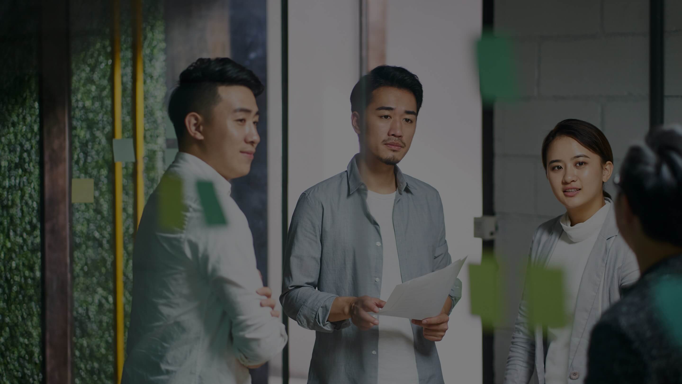 coworkers discussing ideas in office meeting