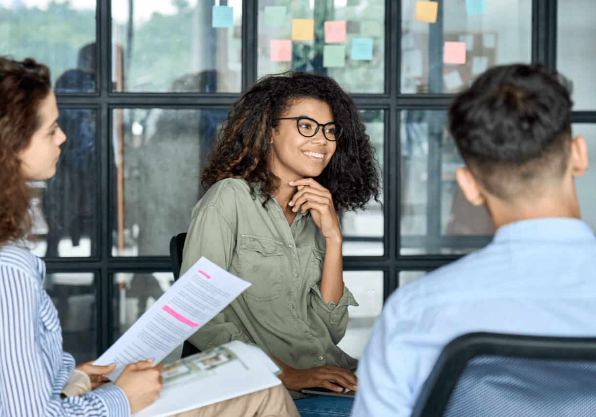 young woman with glasses listening to ideas during a meeting